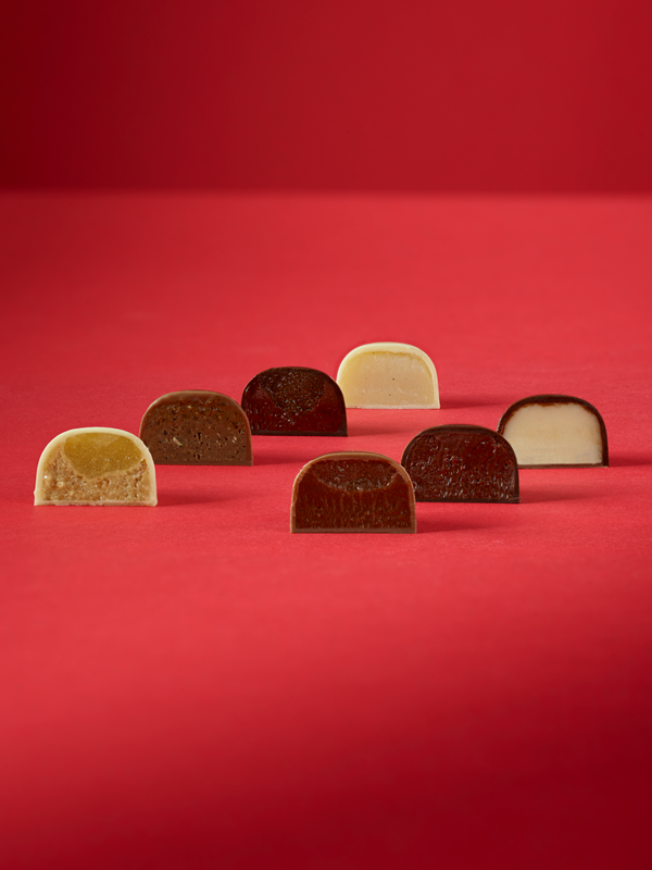 Assorted chocolate pieces on a red background
